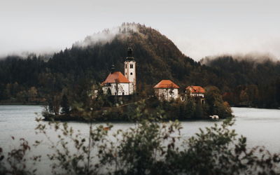 Scenic view of lake by building against sky