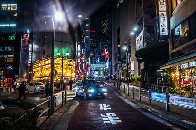 Illuminated city street at night