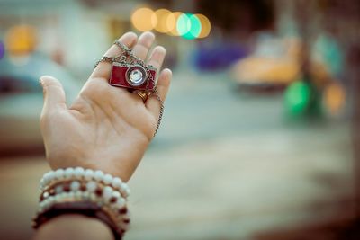 Cropped image of woman holding camera key ring