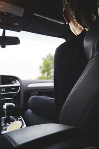 Man sitting in car