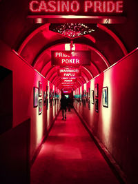 People walking in illuminated corridor