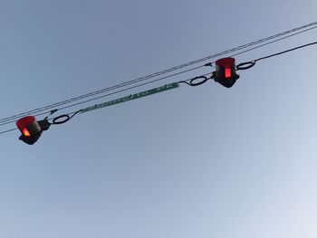 Low angle view of traffic signal against clear sky