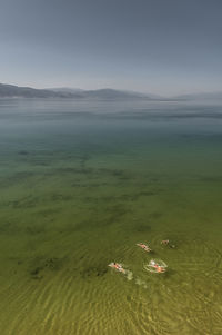 High angle view of people swimming in lake