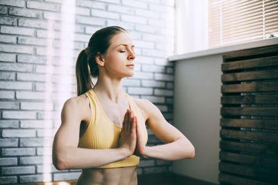 A blonde girl is resting after a fitness class and meditating. the concept of sports 