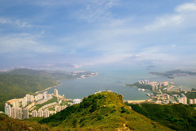 Scenic view of buildings and mountains against sky