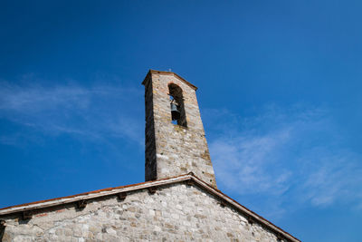 Low angle view of old building against blue sky