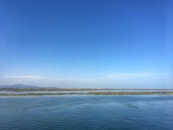 Scenic view of sea against blue sky