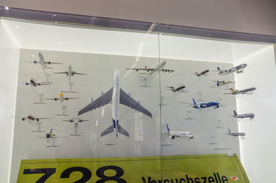 Low angle view of airplane flying against wall