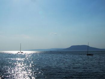 Sailboat in sea against sky