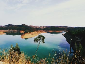 Scenic view of lake and mountains against sky