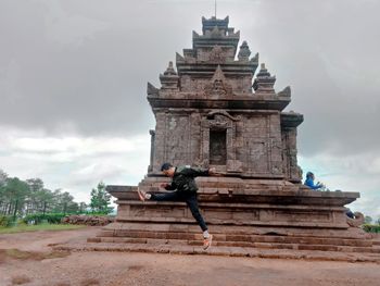 Low angle view of statue against cloudy sky