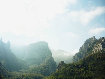 Scenic view of mountains against cloudy sky