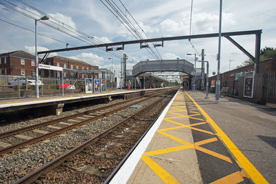 Train at railroad station against sky