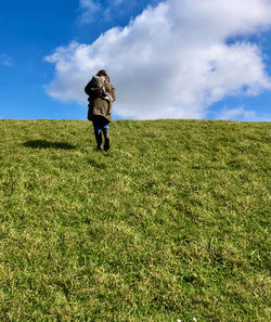 Full length of woman on field against sky