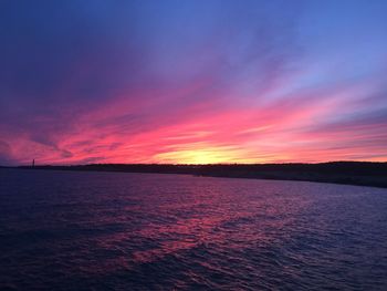 Scenic view of sea against romantic sky at sunset