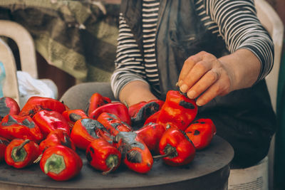 Close-up of hand holding red bell peppers