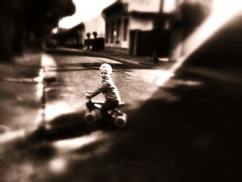 Boy riding bicycle on street