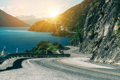 Road by sea against sky