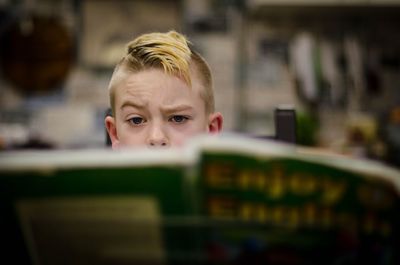 Portrait of boy in book