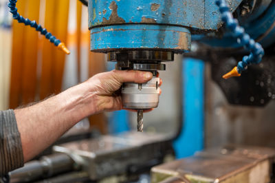Cropped hand of man working in workshop
