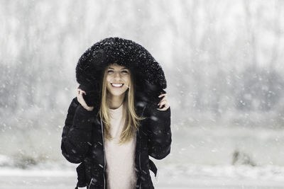 Young woman smiling in snow