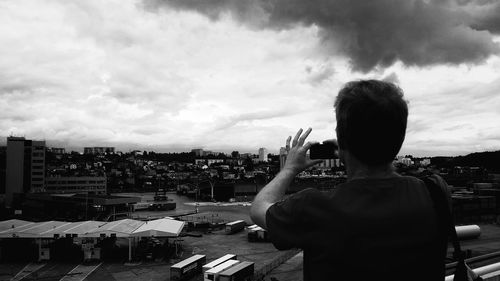 Rear view of a girl looking at cityscape