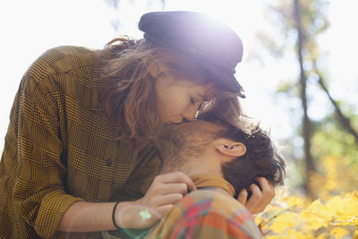 Happy young couple kissing in a park