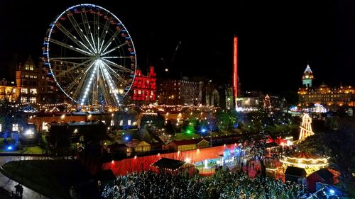 Illuminated ferris wheel at night