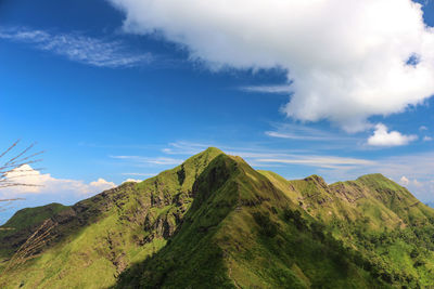 Scenic view of mountains against blue sky