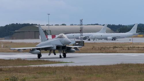 Typhoon landing at raf lossiemouth with two poseidon aircraft in the background