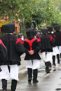 Rear view of people standing in traditional clothing