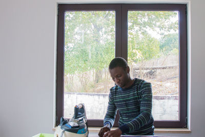 Man looking through window