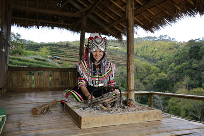 Portrait of girl sitting on wood