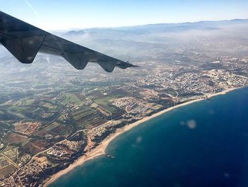 Aerial view of airplane flying over landscape