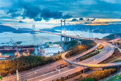 High angle view of bridge over road against cloudy sky