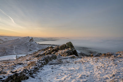 Scenic view of snowcapped mountains against sky during sunset