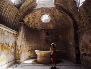 Full length of woman standing in old building