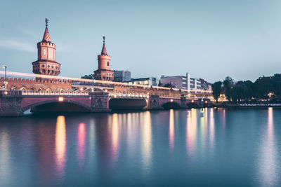 View of bridge over river at night