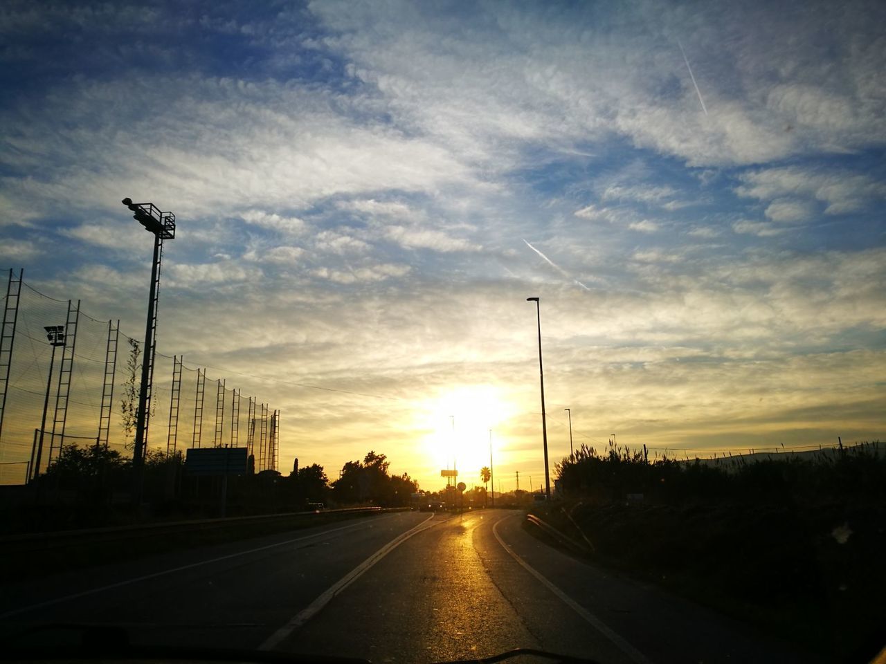 VIEW OF ROAD AGAINST CLOUDY SKY