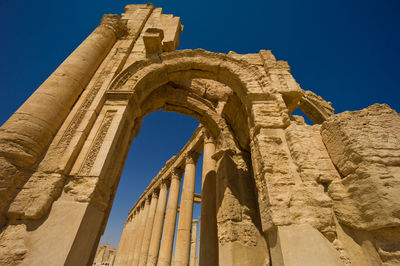 Low angle view of old ruins against clear sky