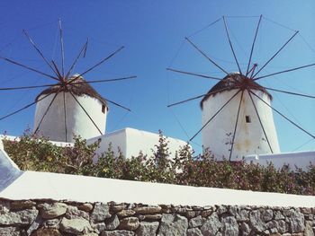 Low angle view of windmill against sky