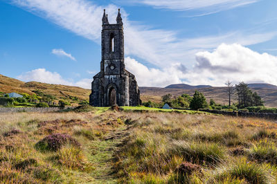 Old ruin on field against sky