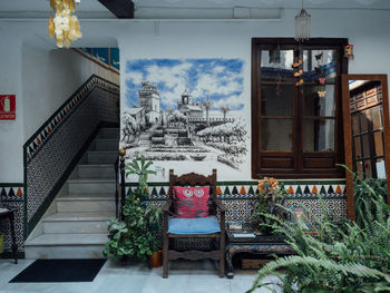 Rear view of potted plants against building