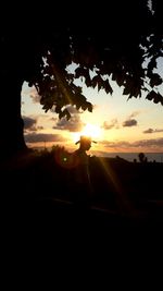 Silhouette of people at sunset