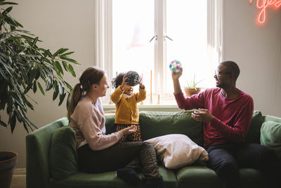 Parents playing with daughter at home