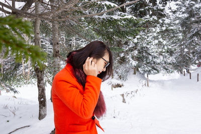 Woman standing on snow covered land