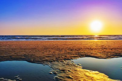 Scenic view of sea against clear sky during sunset