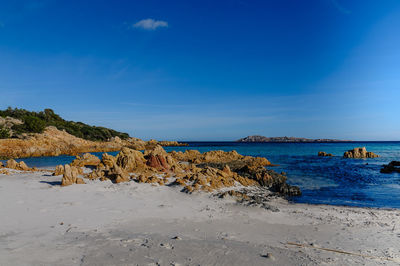 Scenic view of beach against blue sky