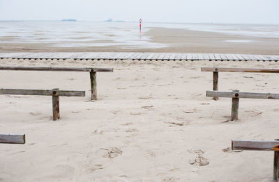 Wooden posts on beach