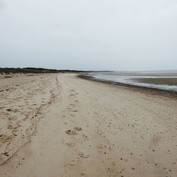 Scenic view of beach against clear sky